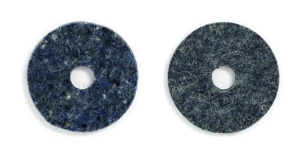 Two blue felt pads on a white surface.