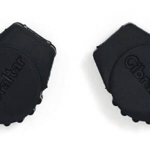 A pair of black plastic caps on a white surface.