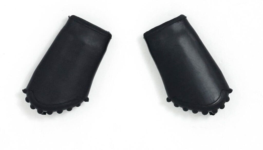 A pair of black rubber gloves on a white surface.