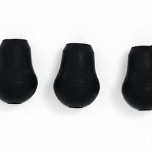 Three black plastic plugs on a white surface.