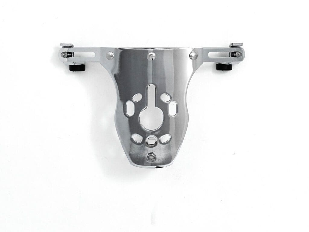 An image of a chrome bracket on a white wall.