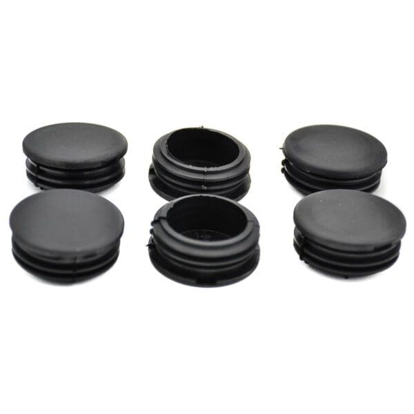 A set of black plastic knobs on a white background.