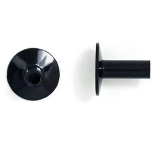 A pair of black plastic knobs on a white surface.