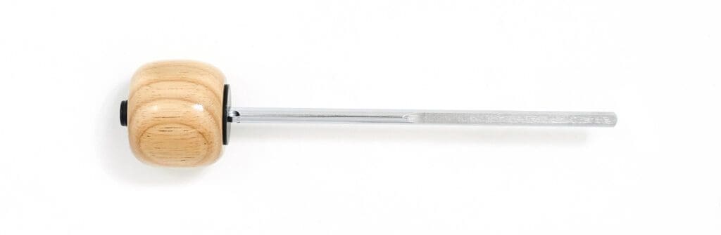 A white brush with a black handle on a white surface.