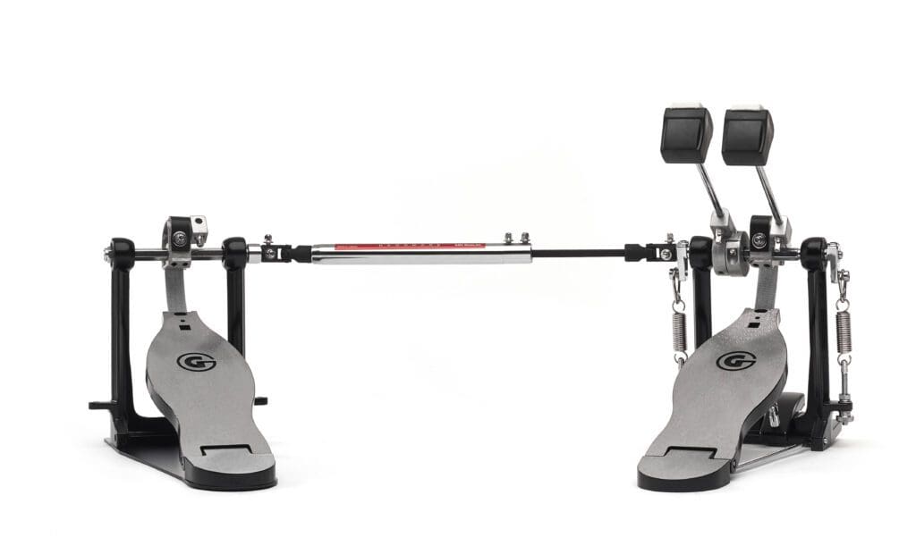 A metal drum pedal with a red knob.