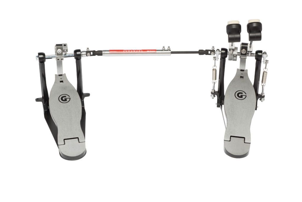 A metal drum pedal with a red knob.