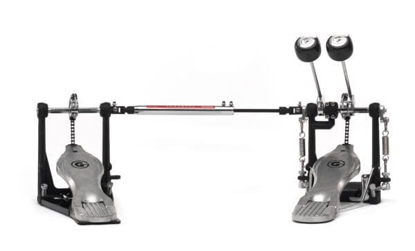 A metal drum pedal with a red knob.