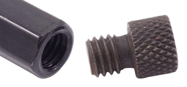 A black screw and nut on a white background.