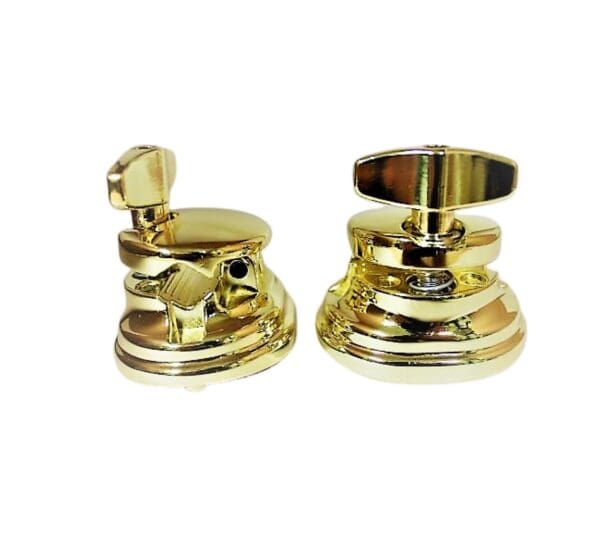 A pair of brass knobs on a white background.