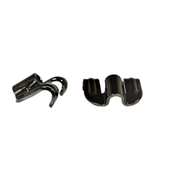 A pair of black plastic clips on a white background.