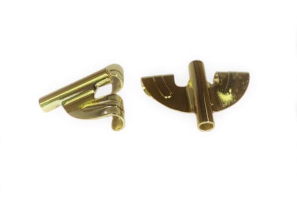 Two gold metal clips on a white background.