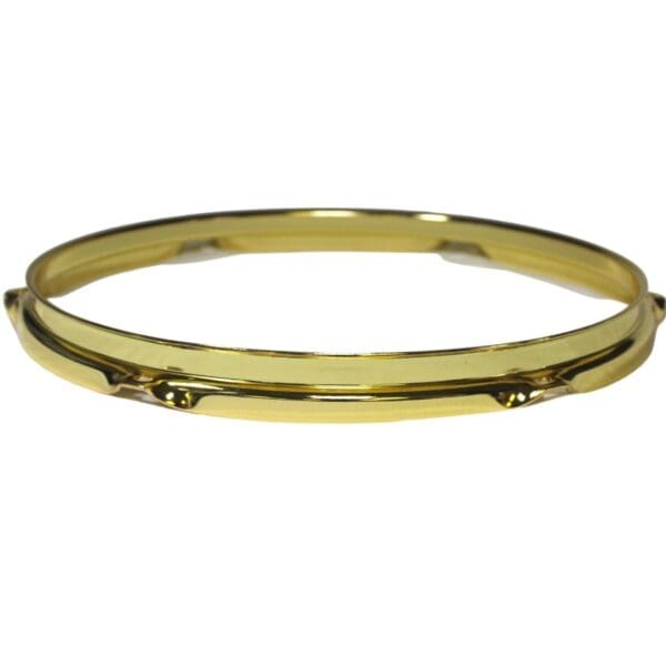 A gold plated bangle bracelet.