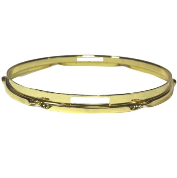 A gold plated bangle on a white background.