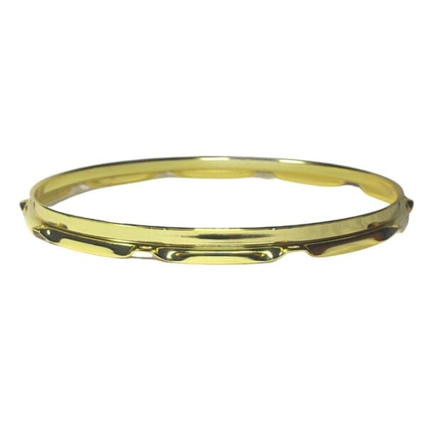 A gold plated bangle on a white background.