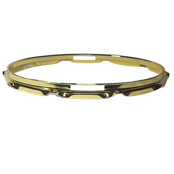 A gold plated bangle on a white background.