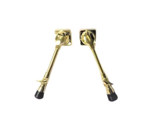 A pair of gold plated brass handles on a white background.